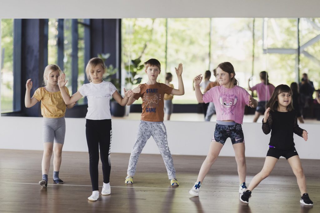 Young children dancing and having fun during a group dance class