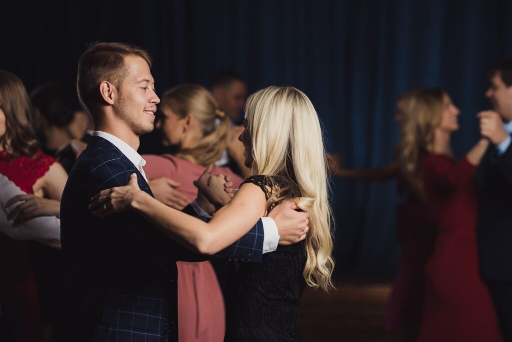 Couples learning basic steps in a beginner-level ballroom and social dance class